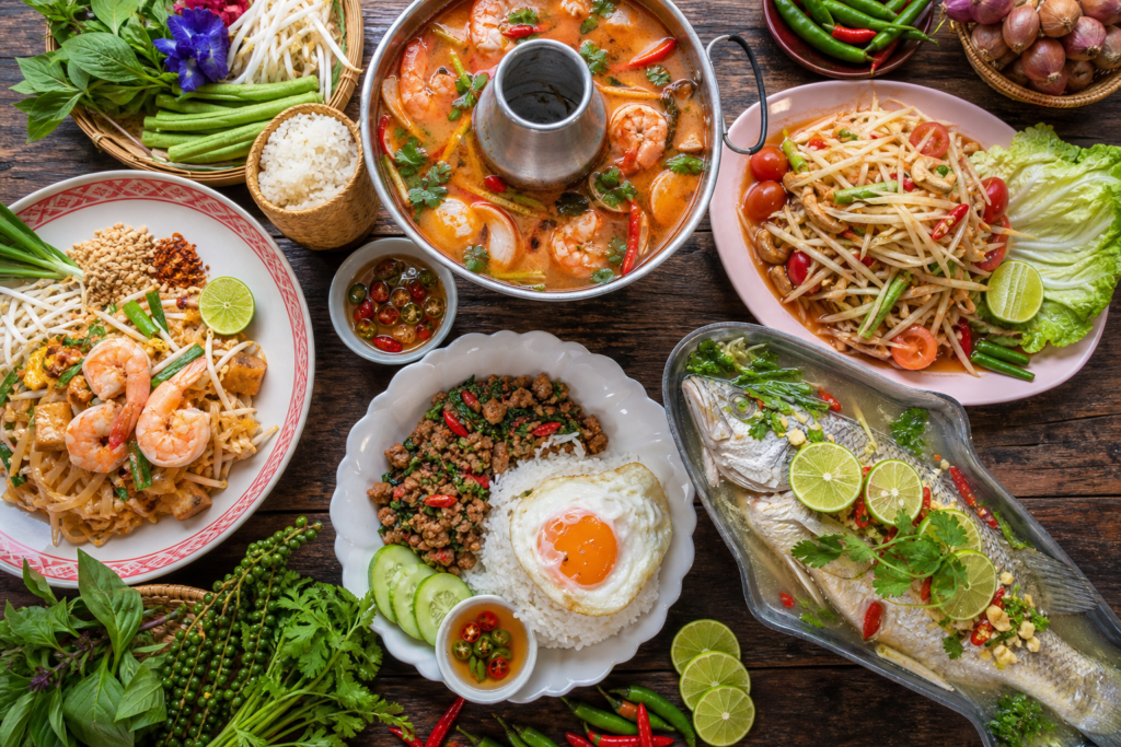 Hom Siam Thai food spread — pad thai, tom yum and papaya salad